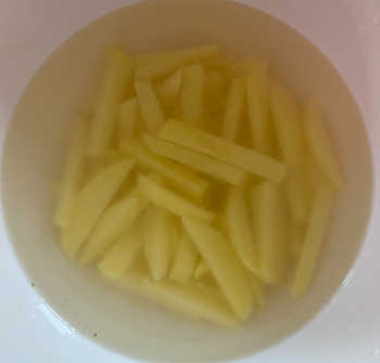 Home made chips soaking in salted water